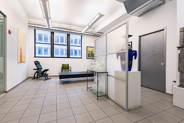 The image shows an interior space that appears to be a modern office or studio, with clean lines and minimalist design.