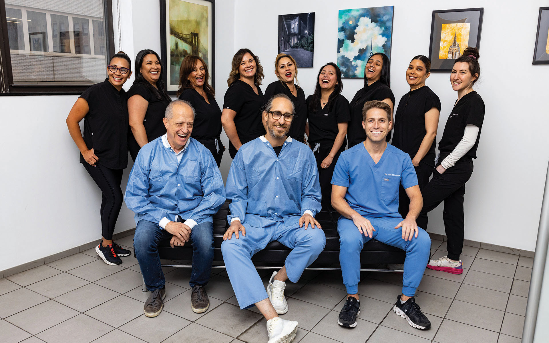 A modern dental practice with a blue and white chair, a dental treatment table, and medical equipment.