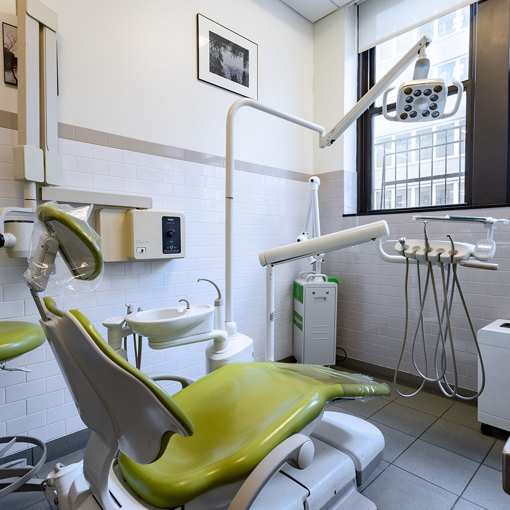 The image shows a modern dental office interior with a chair, sink, and other equipment.