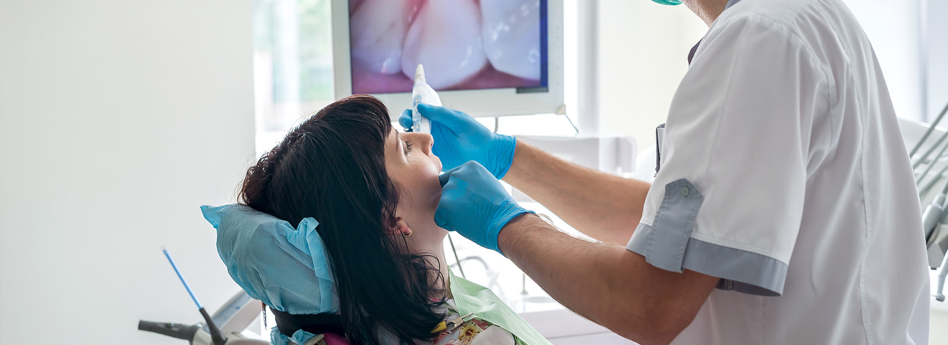 A dental professional assisting a patient during a dental procedure.