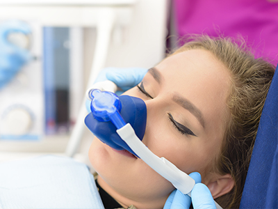 A person receiving oxygen therapy with a medical device attached to their face.